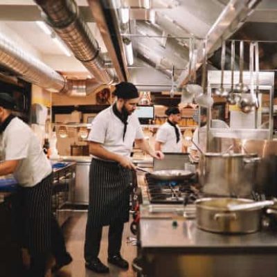 Restaurant kitchen crew preparing food.